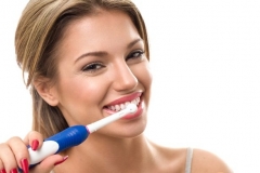 PROD-Young-beautiful-woman-brushing-her-healthy-teeth